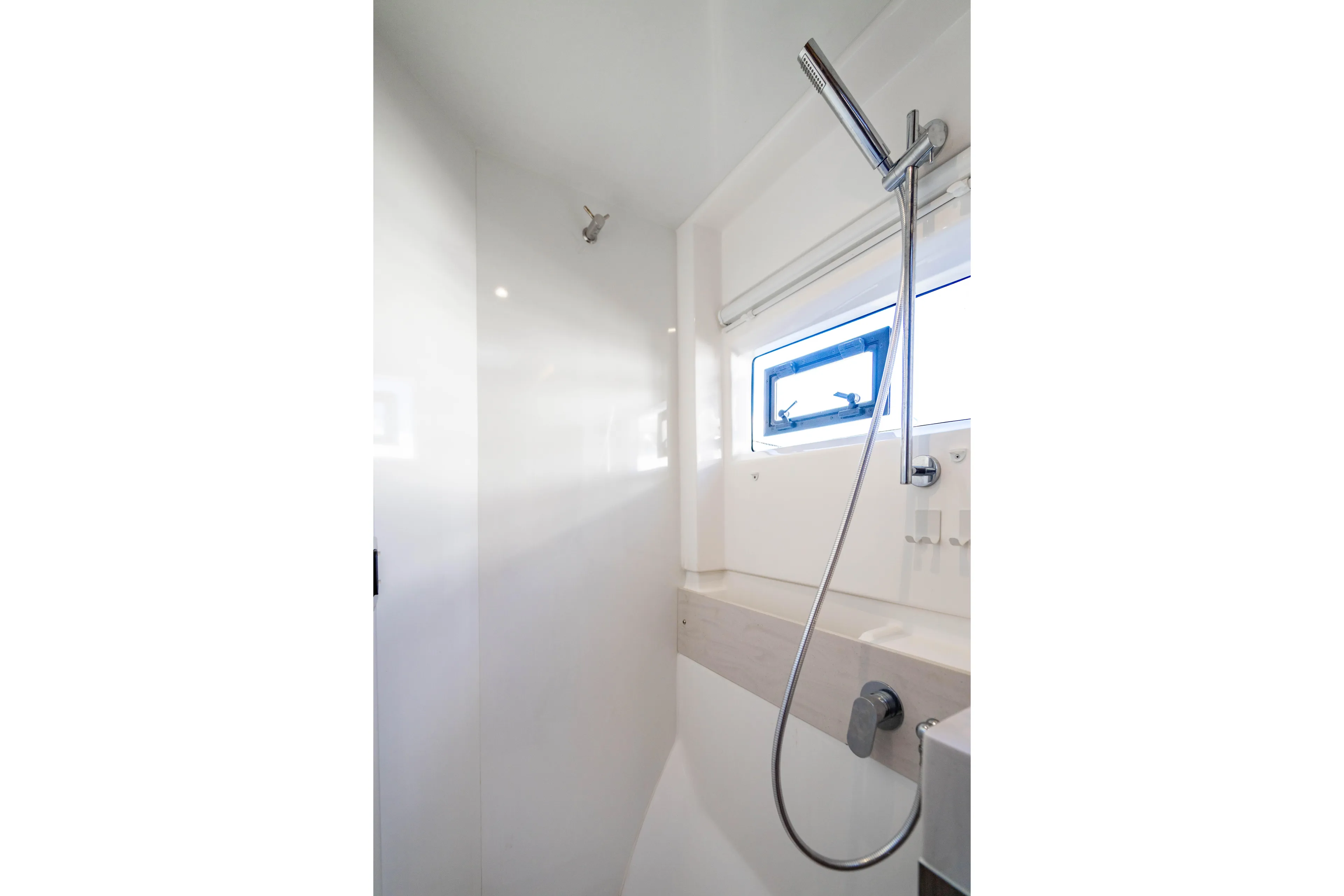 C1022 Yacht Photos Pics Modern shower area in 2025 Leopard 46 yacht with sleek design and window.