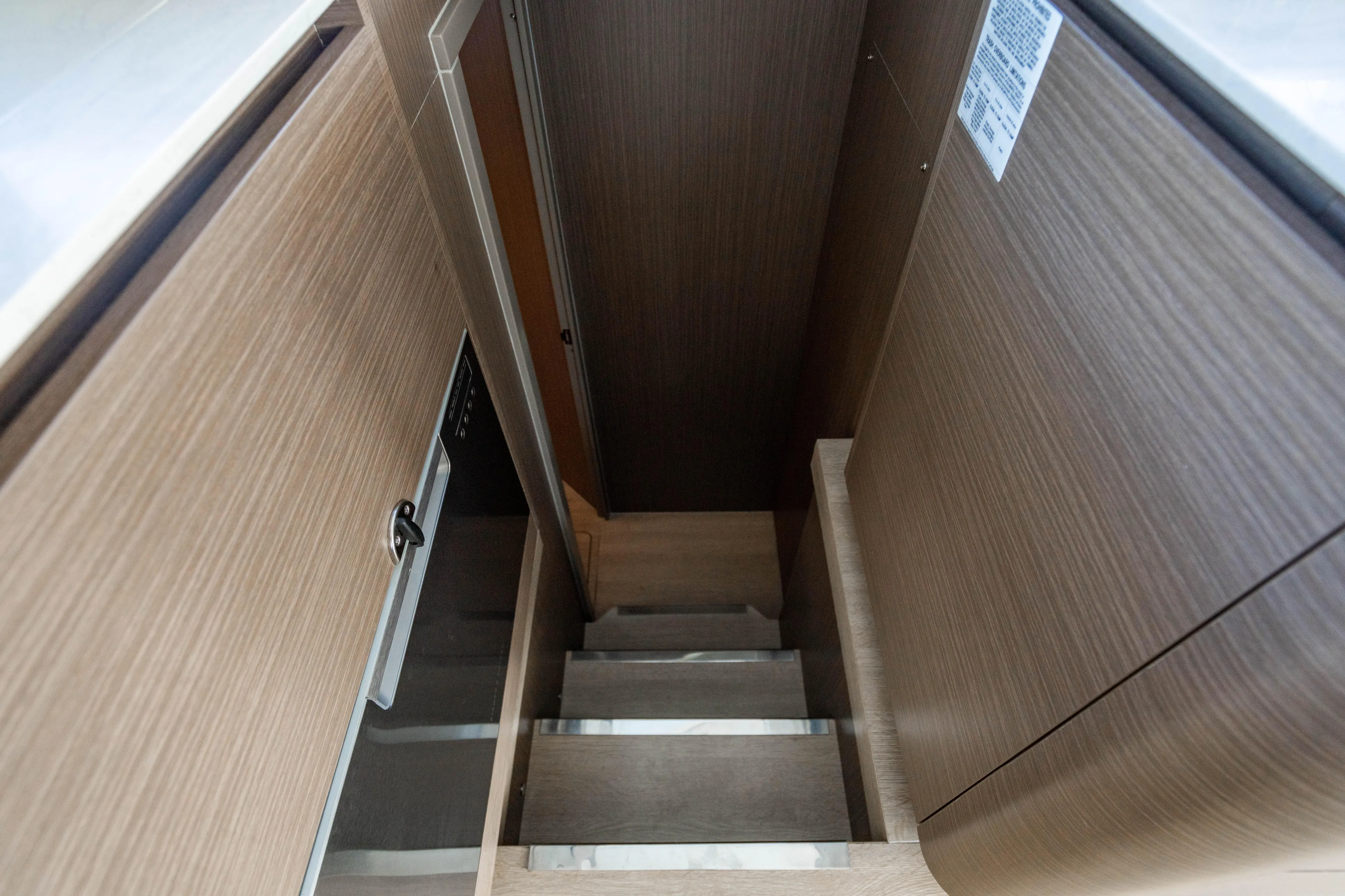 C1022 Yacht Photos Pics Staircase in 2025 Leopard 46 yacht with modern wood paneling.