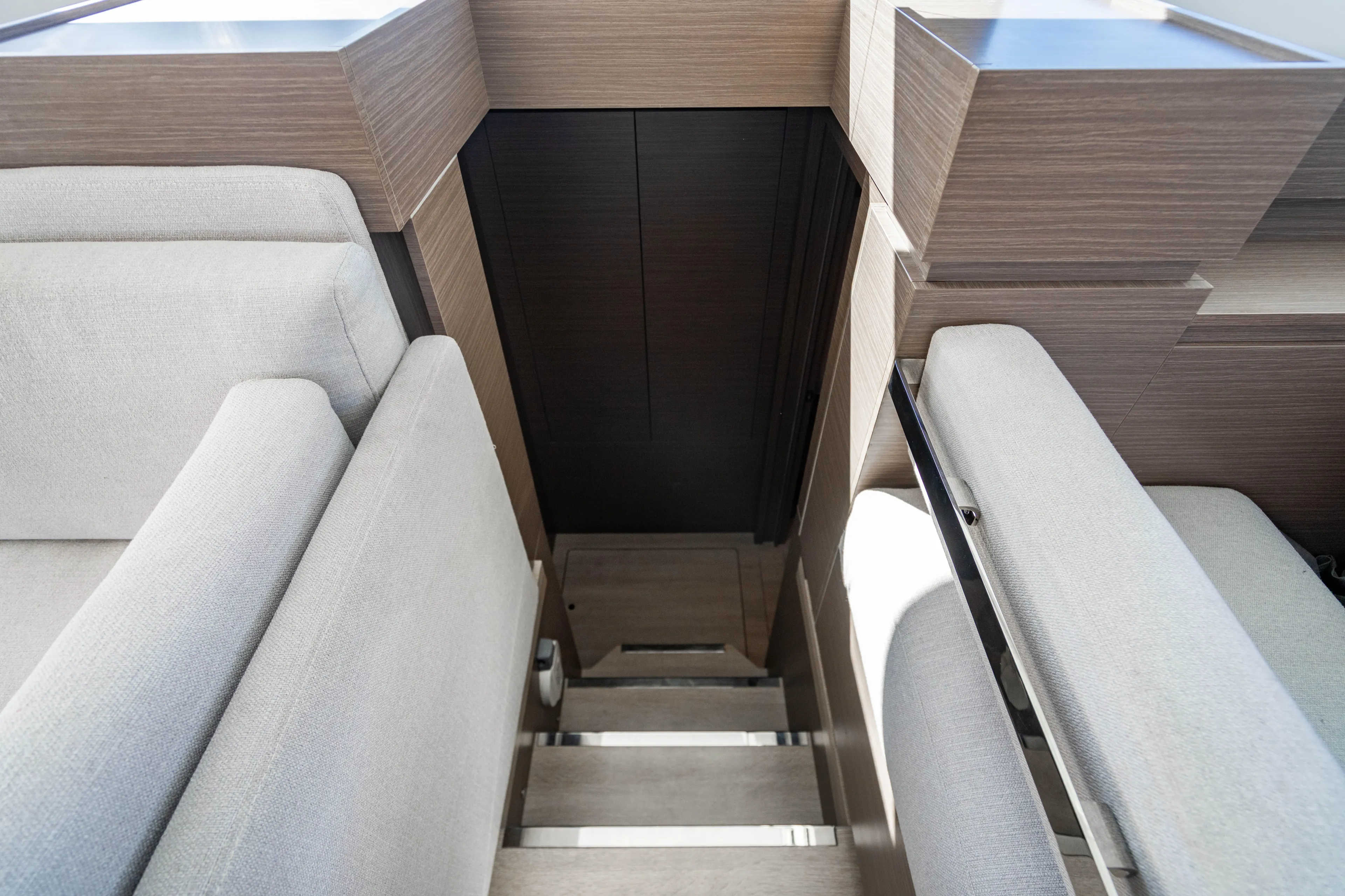 C1022 Yacht Photos Pics Interior stairs of 2025 Leopard 46 yacht with modern wood and fabric design.