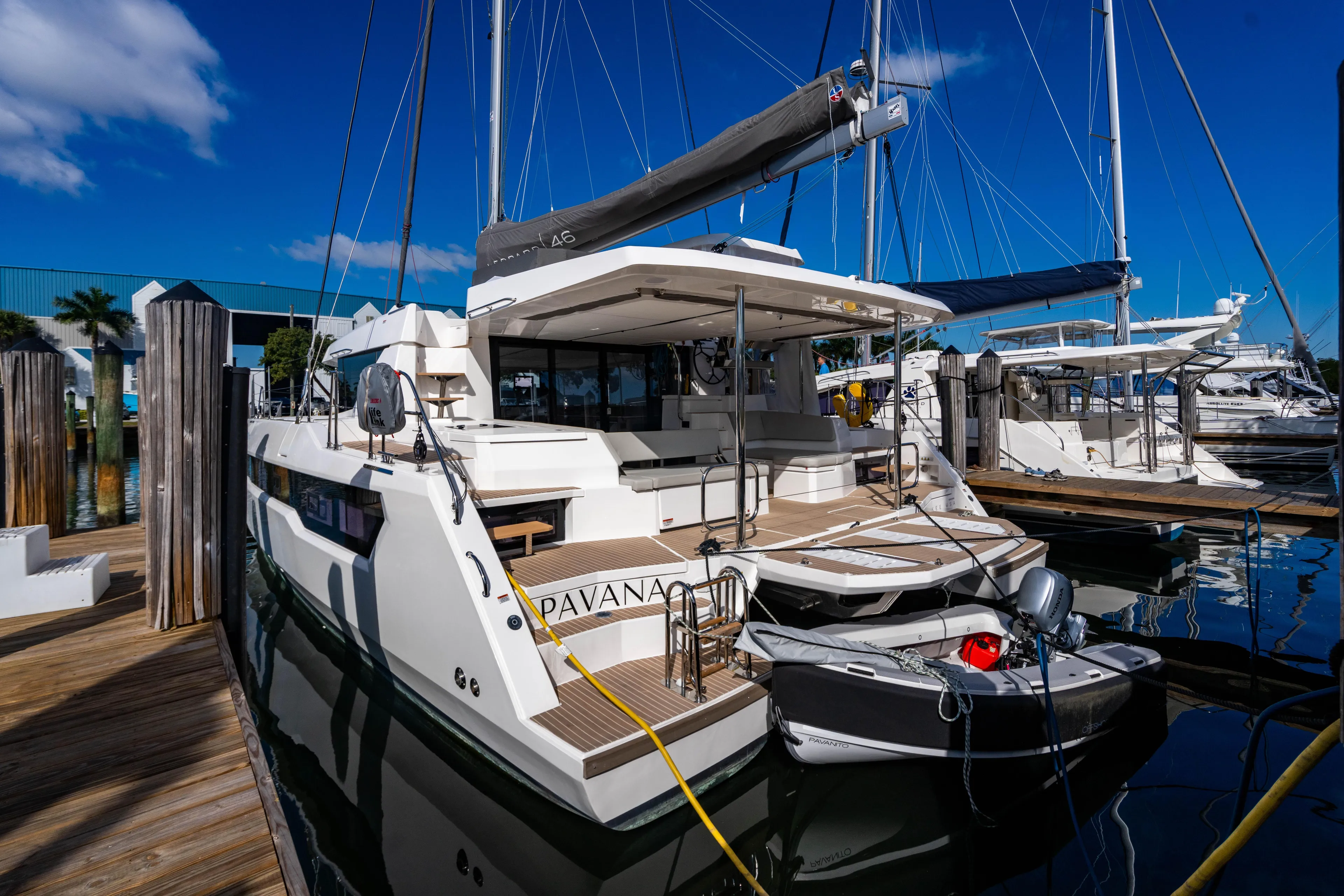 C1022 Yacht Photos Pics Luxury Leopard 46 catamaran docked at marina, 2025 model, with inflatable dinghy attached.