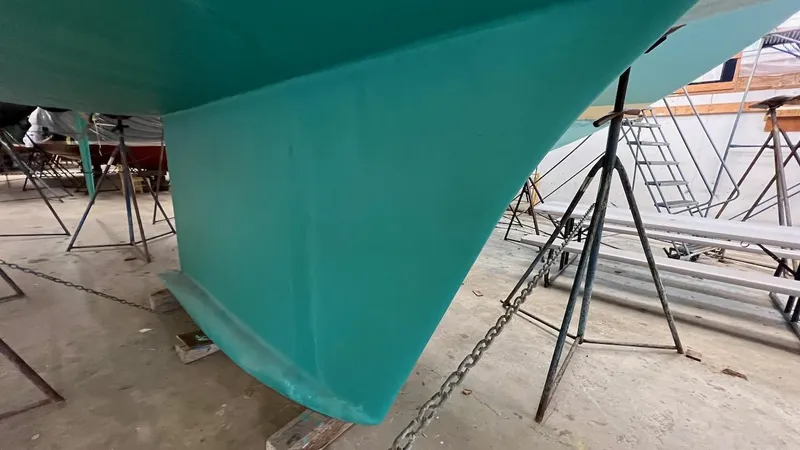 Nala Yacht Photos Pics Lyman-Morse Sparkman & Stephens Sloop 2004, teal hull, in dry dock with support stands.