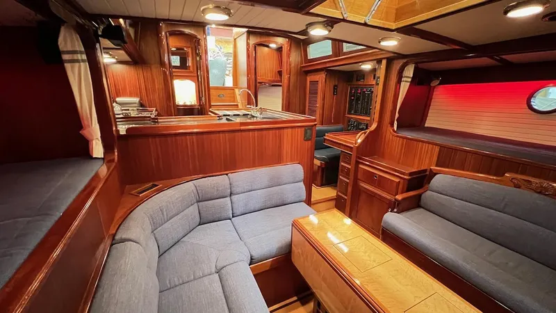 Nala Yacht Photos Pics Luxurious 2004 Lyman-Morse Sparkman & Stephens Sloop interior with elegant wood finish and cozy seating.