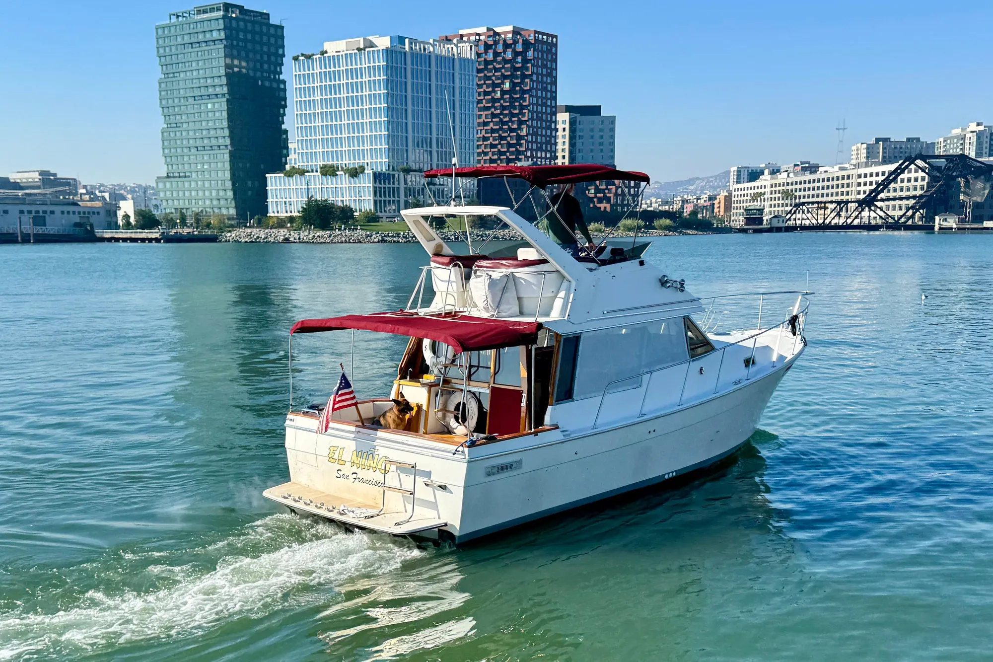1989 Bayliner 3288 Motoryacht cruising in urban waterfront setting.