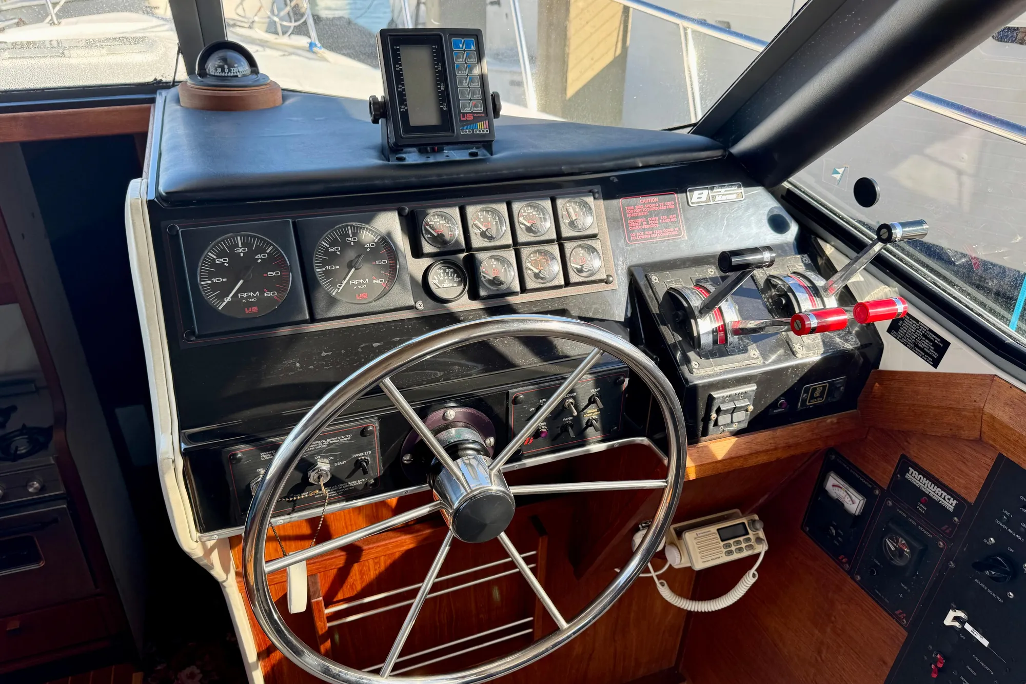 1989 Bayliner 3288 Motoryacht helm with steering wheel, gauges, and controls.