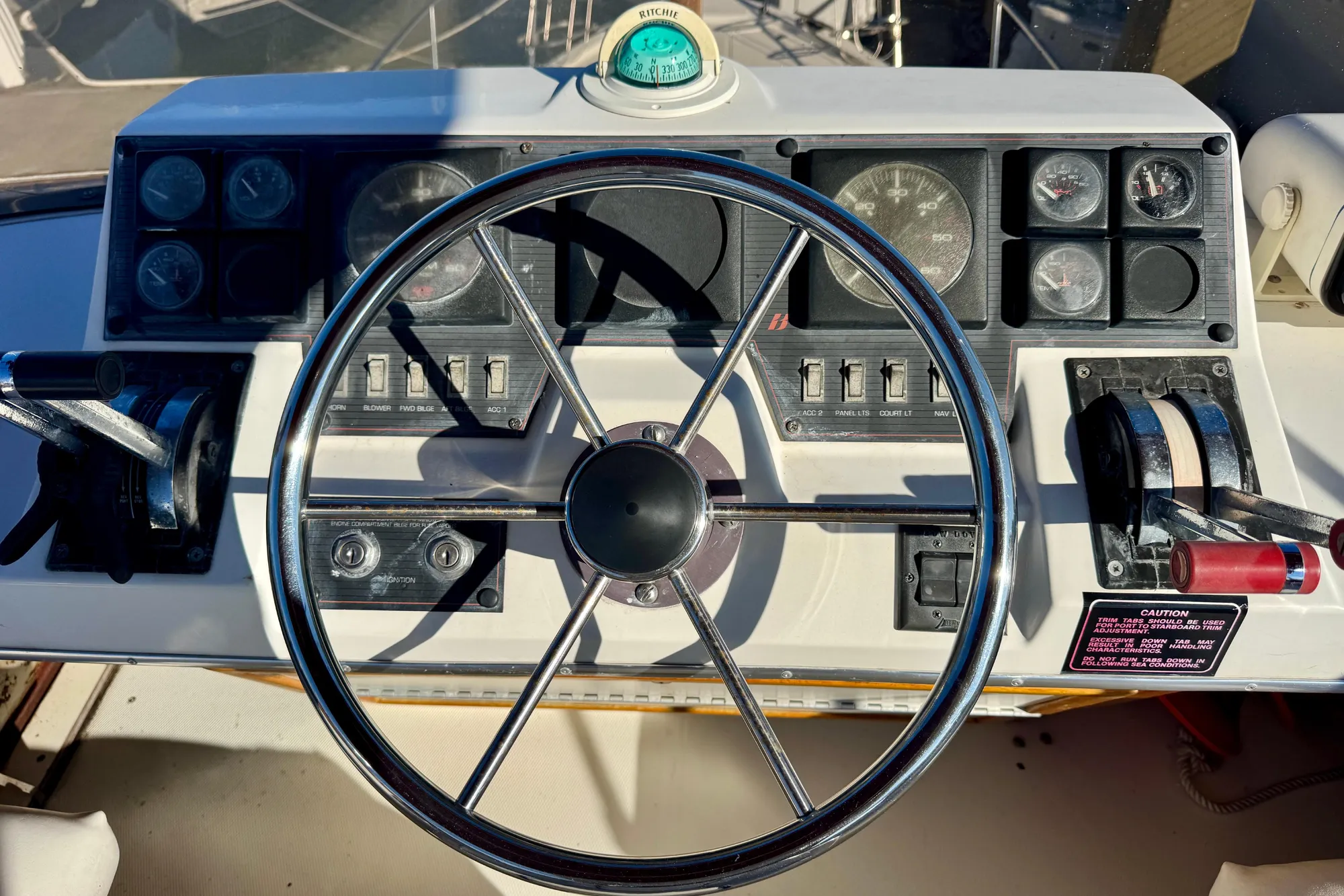 1989 Bayliner 3288 Motoryacht helm with steering wheel and control panel.