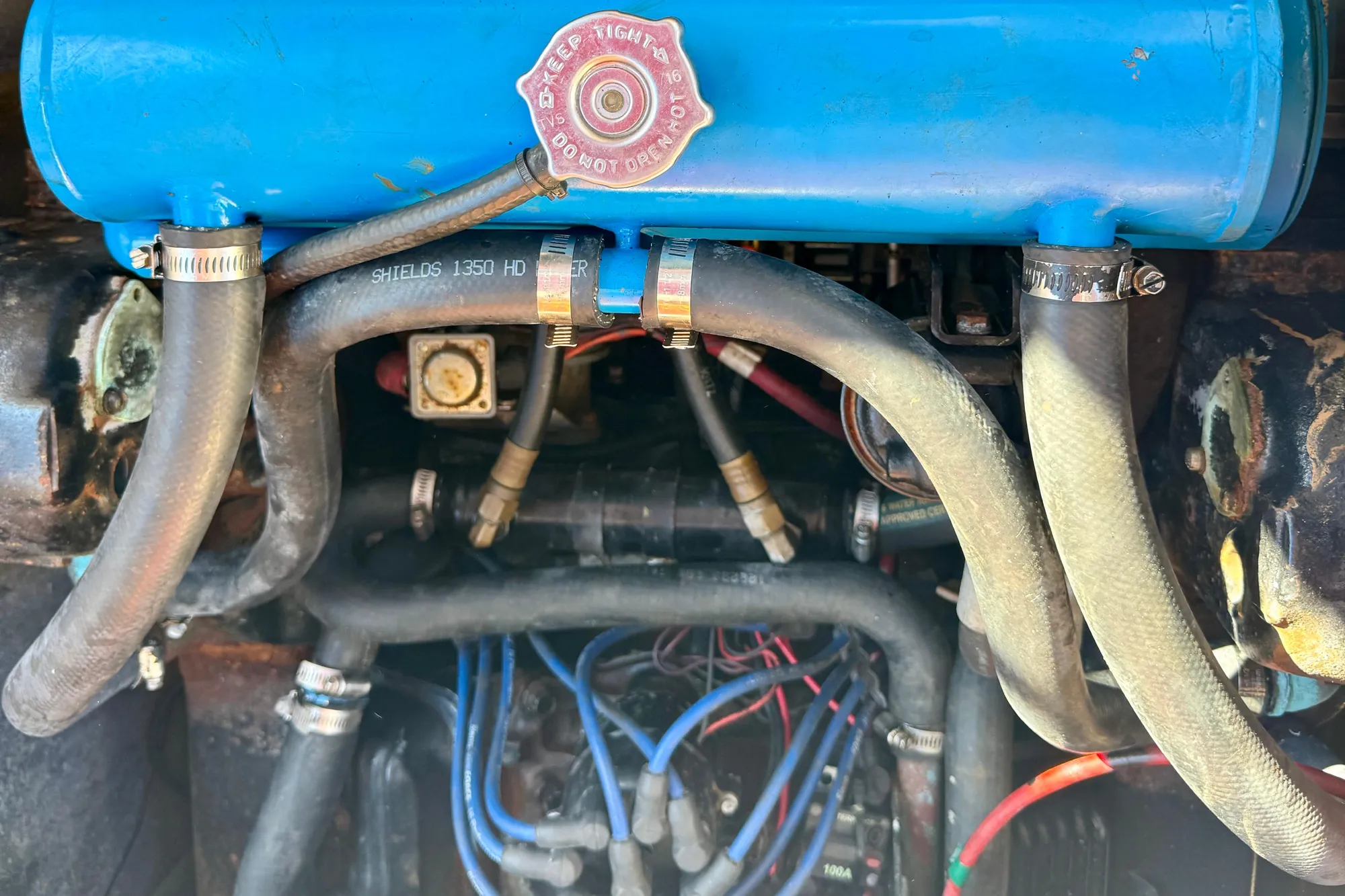 Engine compartment of a 1989 Bayliner 3288 Motoryacht, showing hoses and components.