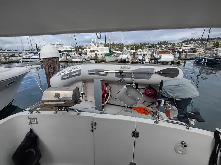 Salish Nomad Yacht Photos Pics 2007 American Tug 34 at marina with dinghy and equipment on deck.