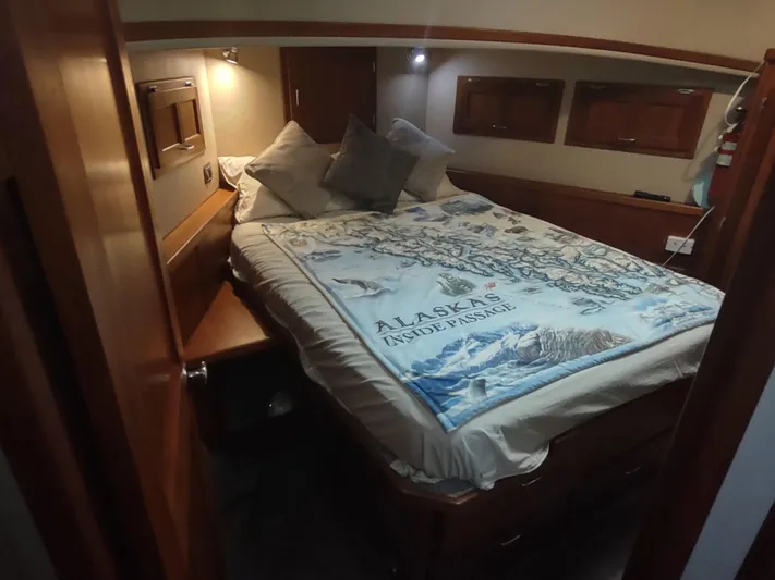 Salish Nomad Yacht Photos Pics Cozy cabin interior of 2007 American Tug 34 with Alaska-themed bedding.