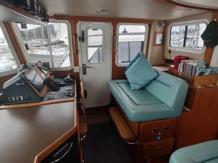 Salish Nomad Yacht Photos Pics 2007 American Tug 34 interior with helm, seating, and nautical decor.