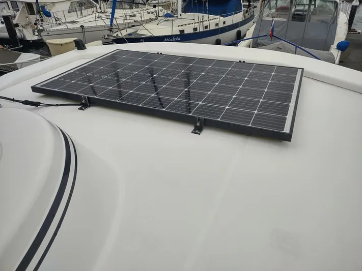 Salish Nomad Yacht Photos Pics Solar panel on 2007 American Tug 34 boat roof at marina.