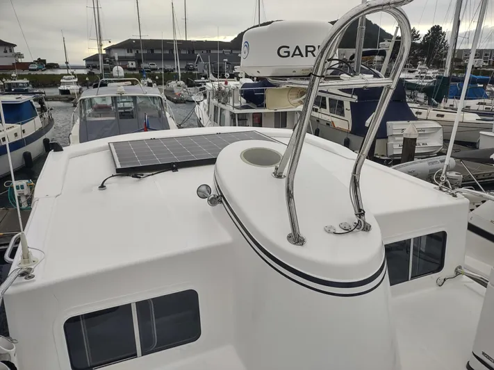 Salish Nomad Yacht Photos Pics 2007 American Tug 34 with solar panel, docked in marina.