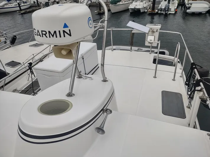 Salish Nomad Yacht Photos Pics 2007 American Tug 34 boat deck with Garmin radar, docked in marina.