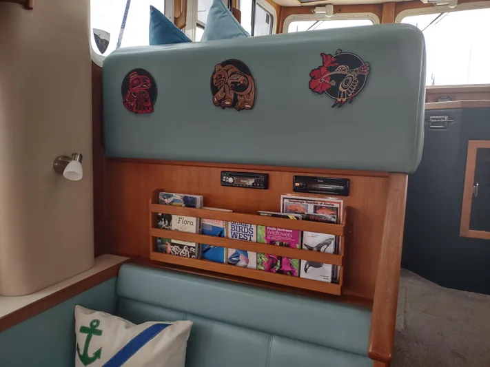 Salish Nomad Yacht Photos Pics Interior of 2007 American Tug 34 with decorative art and bookshelf.