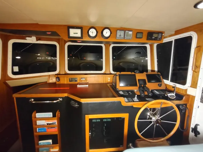 Salish Nomad Yacht Photos Pics 2007 American Tug 34 helm with navigation instruments and wooden steering wheel.