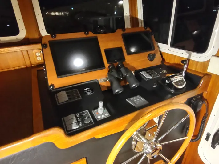 Salish Nomad Yacht Photos Pics 2007 American Tug 34 helm with navigation screens and controls.