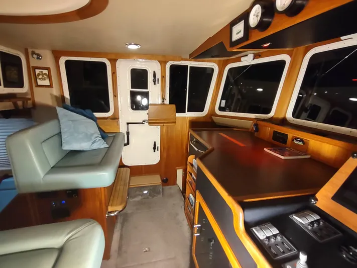 Salish Nomad Yacht Photos Pics Interior of 2007 American Tug 34, featuring helm station and seating area.