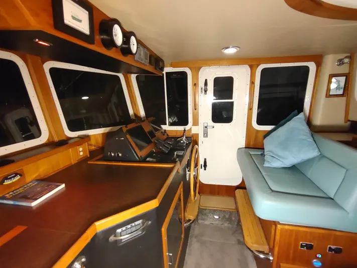 Salish Nomad Yacht Photos Pics Interior of 2007 American Tug 34, featuring helm and seating area.