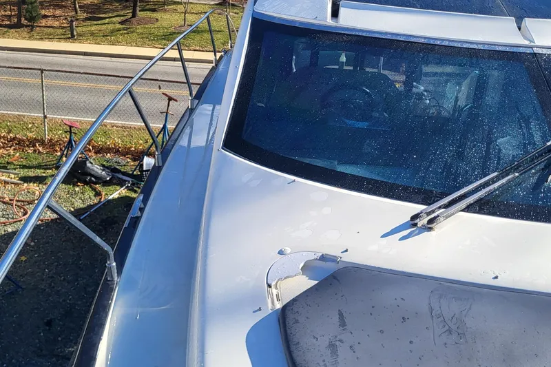  Yacht Photos Pics 2008 Marquis 40 SC yacht deck with windshield and railing, parked near a road.