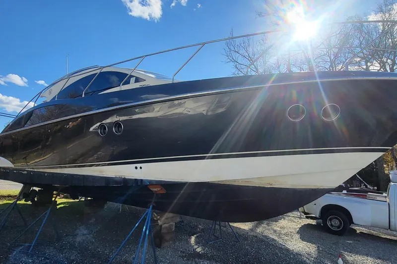  Yacht Photos Pics 2008 Marquis 40 SC yacht on stands, sunlit, with a clear blue sky background.