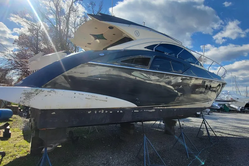  Yacht Photos Pics 2008 Marquis 40 SC yacht on stands under a partly cloudy sky.