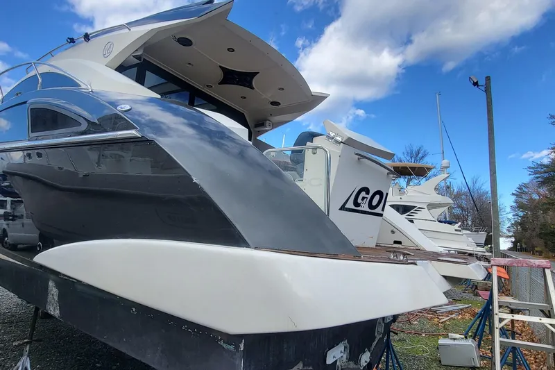 Yacht Photos Pics 2008 Marquis 40 SC yacht on dry dock under a blue sky.