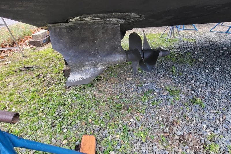  Yacht Photos Pics Propeller and rudder of a 2008 Marquis 40 SC yacht on gravel and grass.