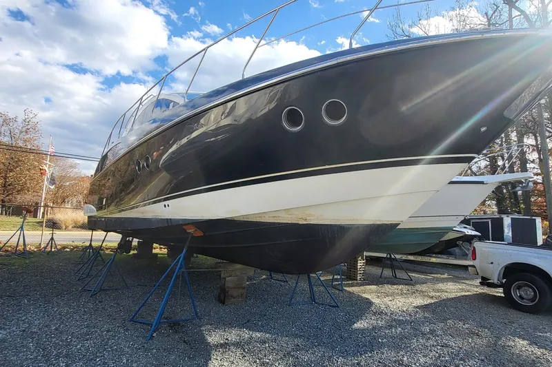  Yacht Photos Pics 2008 Marquis 40 SC yacht on stands, black hull, outdoor storage.