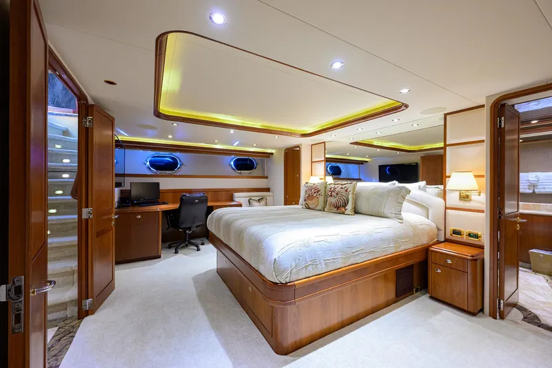 Exodus Yacht Photos Pics Luxurious bedroom interior on 2008 Westport 112 yacht, featuring elegant wood finishes and modern amenities.