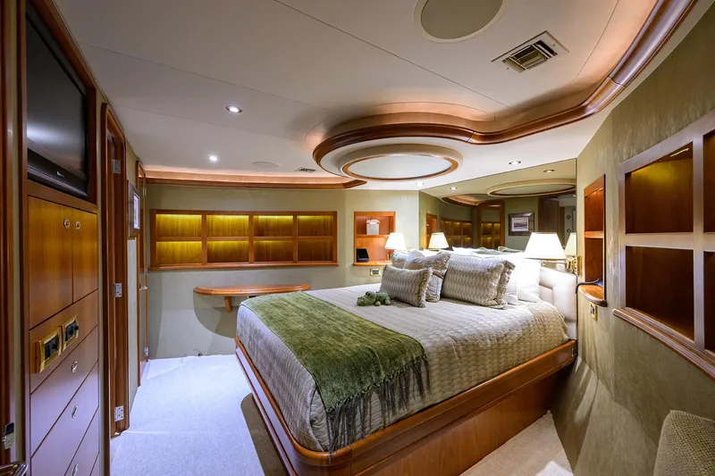 Exodus Yacht Photos Pics Luxurious bedroom interior on 2008 Westport 112 yacht, featuring elegant wood accents and ambient lighting.