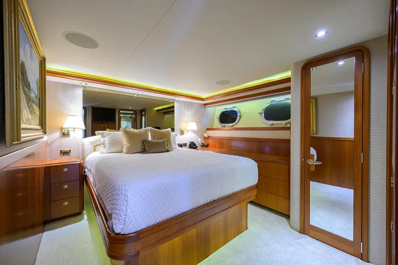 Exodus Yacht Photos Pics Luxurious bedroom interior of 2008 Westport 112 yacht with elegant wood finishes.