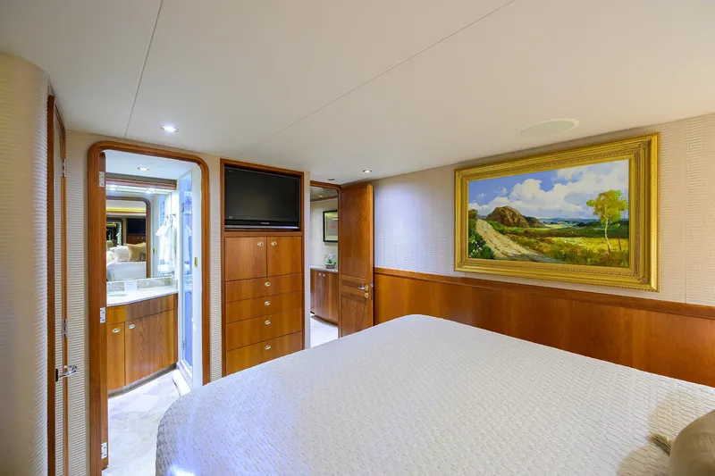 Exodus Yacht Photos Pics Luxurious bedroom interior on 2008 Westport 112 yacht with elegant wood paneling and artwork.