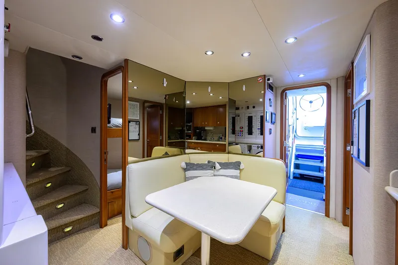 Exodus Yacht Photos Pics Luxurious interior of 2008 Westport 112 yacht with cozy dining area and modern lighting.