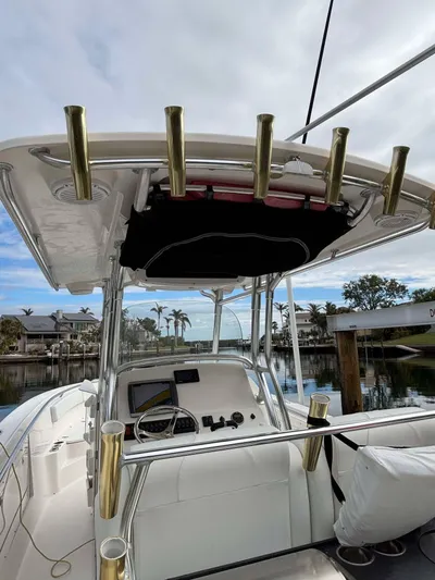  Yacht Photos Pics 2012 Edgewater 318CC boat with fishing rod holders, docked in a marina.
