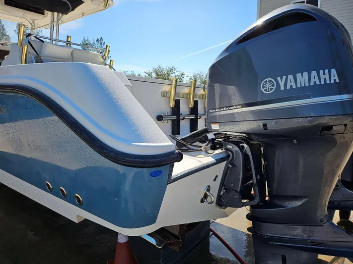  Yacht Photos Pics Edgewater 318CC 2012 boat with Yamaha outboard motor, docked outdoors.