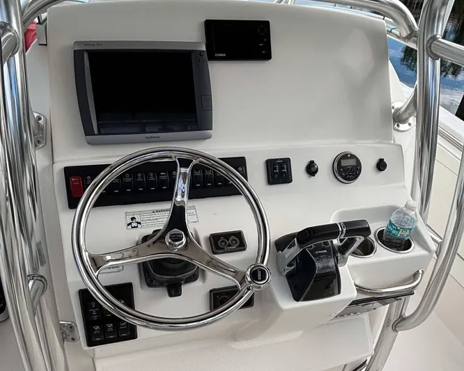  Yacht Photos Pics Control panel of a 2012 Edgewater 318CC boat with steering wheel and navigation equipment.