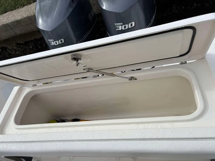  Yacht Photos Pics Open storage compartment on 2012 Edgewater 318CC boat with Yamaha 300 engines visible.