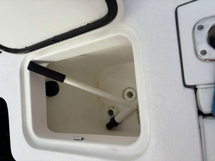  Yacht Photos Pics Open storage compartment on 2012 Edgewater 318CC boat with white interior.