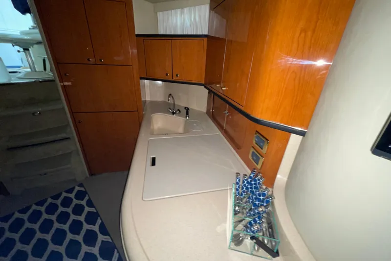  Yacht Photos Pics 2001 Sea Ray Sundancer 460 yacht interior with wooden cabinets and modern kitchenette.