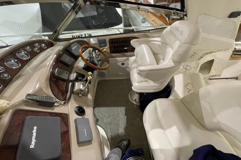  Yacht Photos Pics Cockpit of 2001 Sea Ray Sundancer 460 with steering wheel and navigation equipment.
