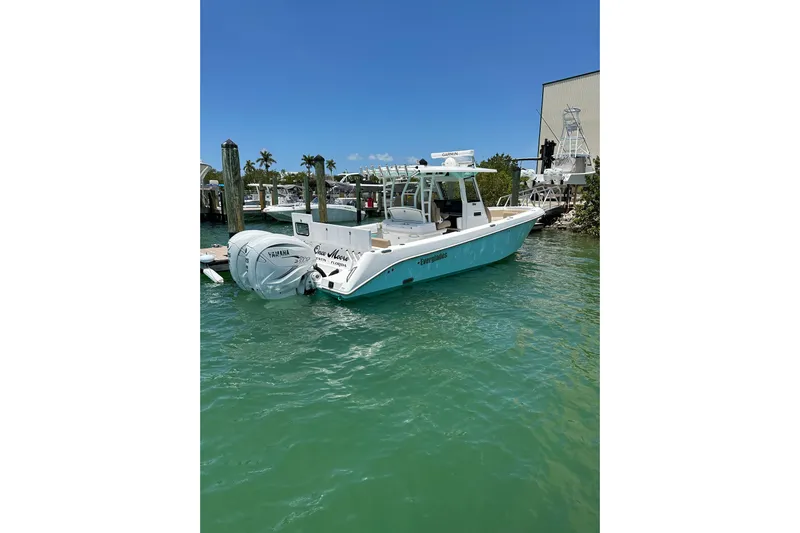  Yacht Photos Pics 2020 Everglades 335 Center Console boat docked in clear blue water.