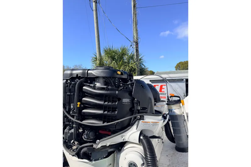  Yacht Photos Pics Outboard engine of a 2020 Everglades 335 Center Console boat under a clear blue sky.