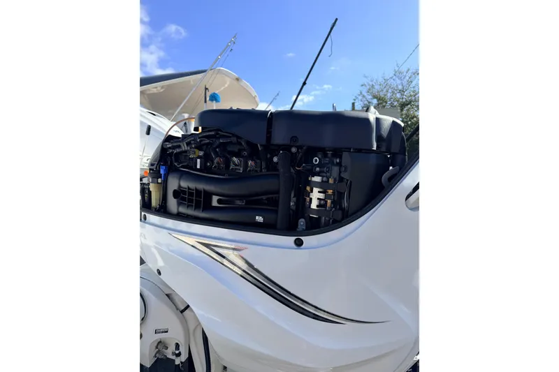  Yacht Photos Pics 2020 Everglades 335 Center Console boat engine close-up under blue sky.