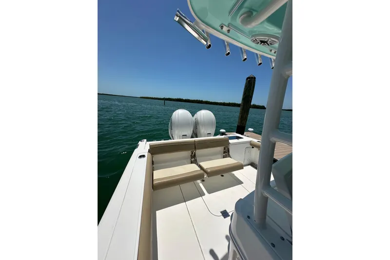  Yacht Photos Pics 2020 Everglades 335 Center Console boat docked on calm water.