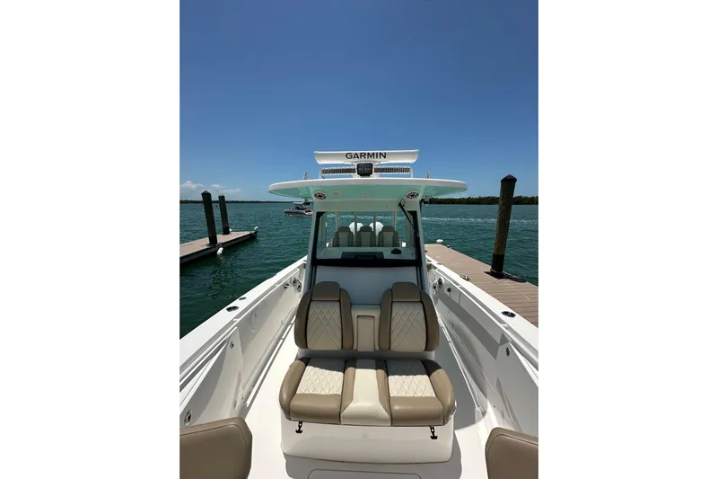 Yacht Photos Pics 2020 Everglades 335 Center Console boat docked, featuring Garmin equipment under clear blue sky.