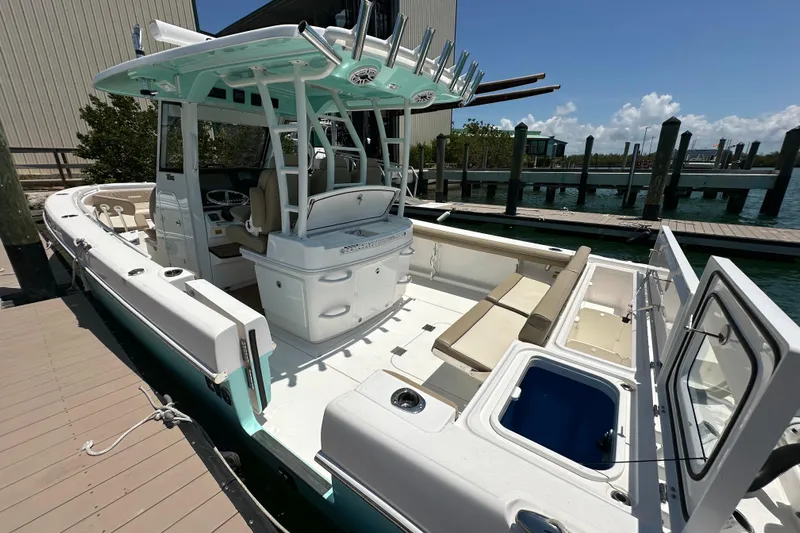  Yacht Photos Pics 2020 Everglades 335 Center Console boat docked, featuring spacious seating and modern amenities.