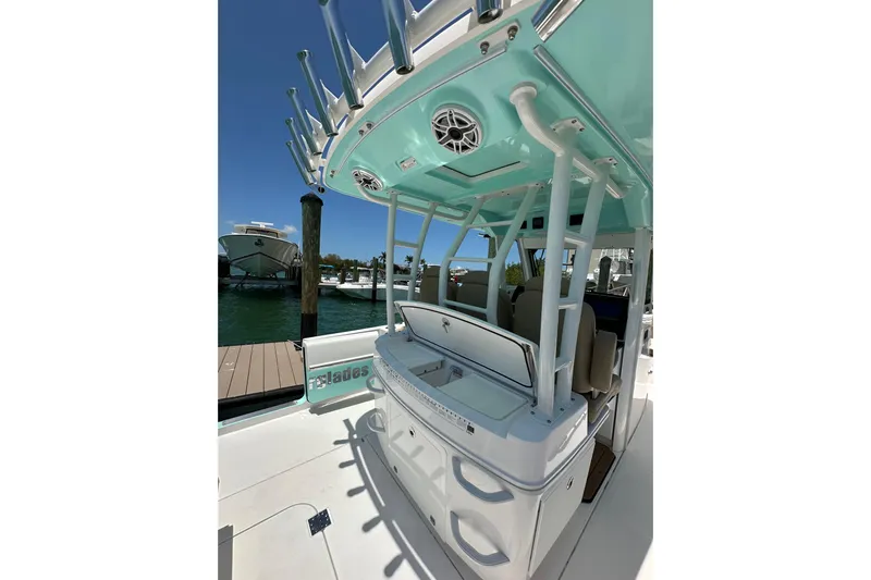  Yacht Photos Pics 2020 Everglades 335 Center Console boat interior with teal accents and fishing rod holders.