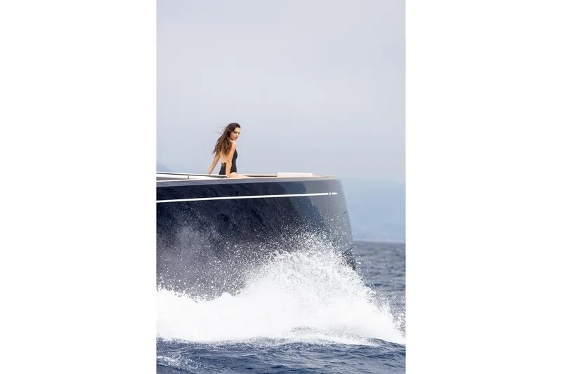 Sirocco Yacht Photos Pics 2021 Pardo Yachts 43 cruising with waves splashing, person enjoying the view.