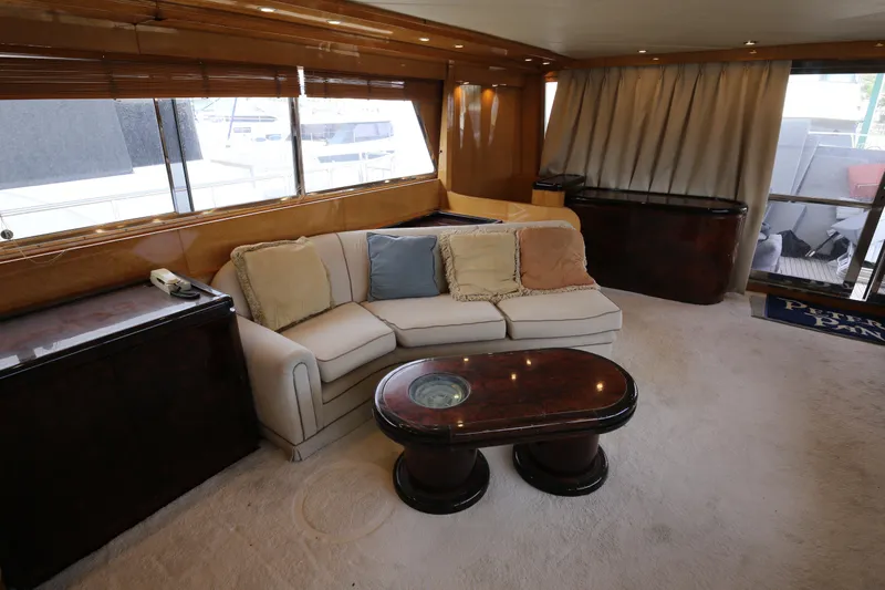  Yacht Photos Pics Luxurious interior of a 1990 Sanlorenzo 80 yacht with elegant seating and wooden accents.
