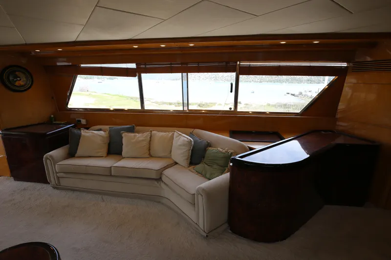  Yacht Photos Pics Luxurious interior of 1990 Sanlorenzo 80 yacht with plush seating and large windows.