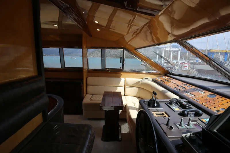  Yacht Photos Pics Interior of 1990 Sanlorenzo 80 yacht with luxurious seating and control panel.